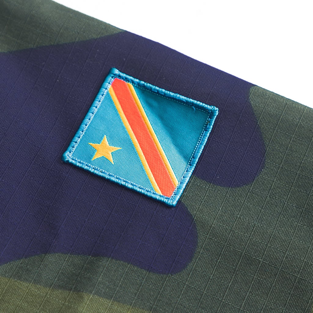 Close-up of the Democratic Republic of Congo flag patch on the sleeve of the custom DRC green camo uniform.