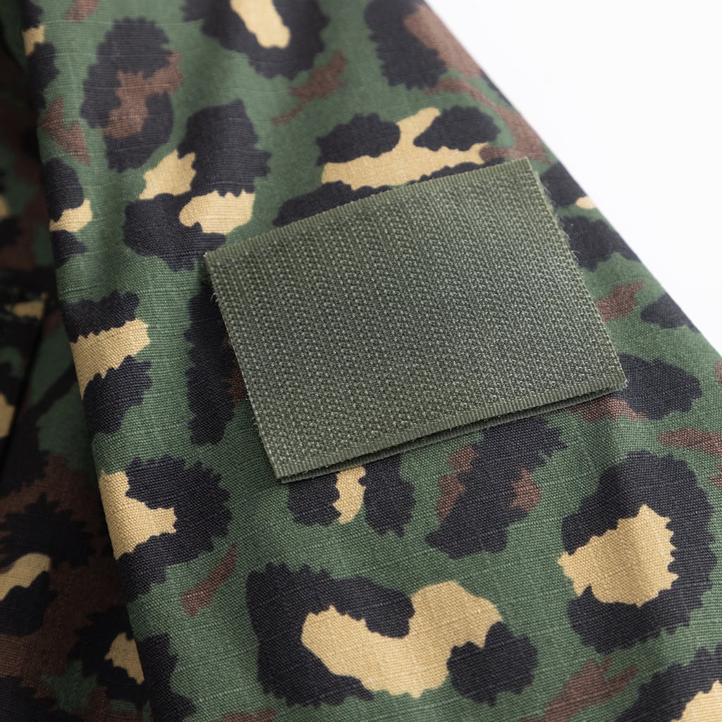 Close-up detail of a velcro patch on the sleeve of the custom leopard camo BDU uniform jacket.