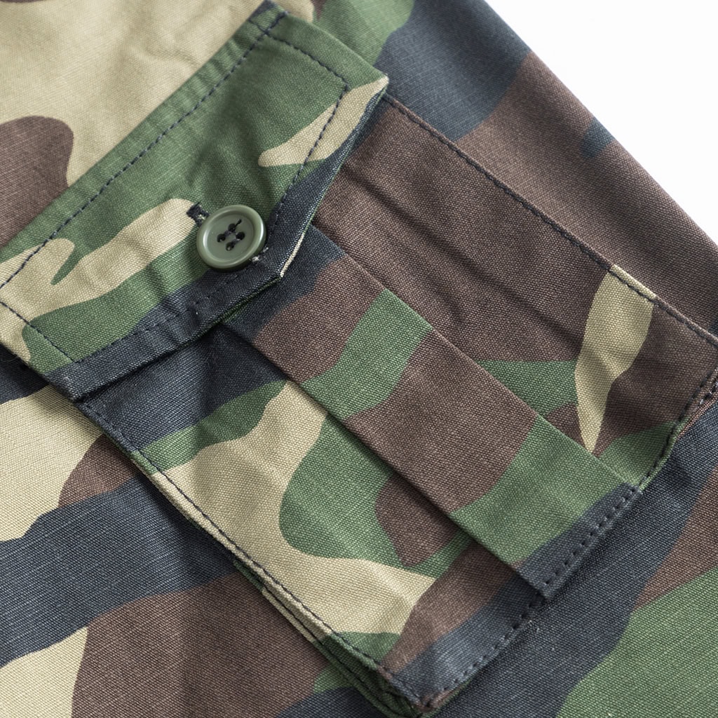 Detail of the buttoned arm pocket on the sleeve of the custom woodland camo combat uniform jacket.