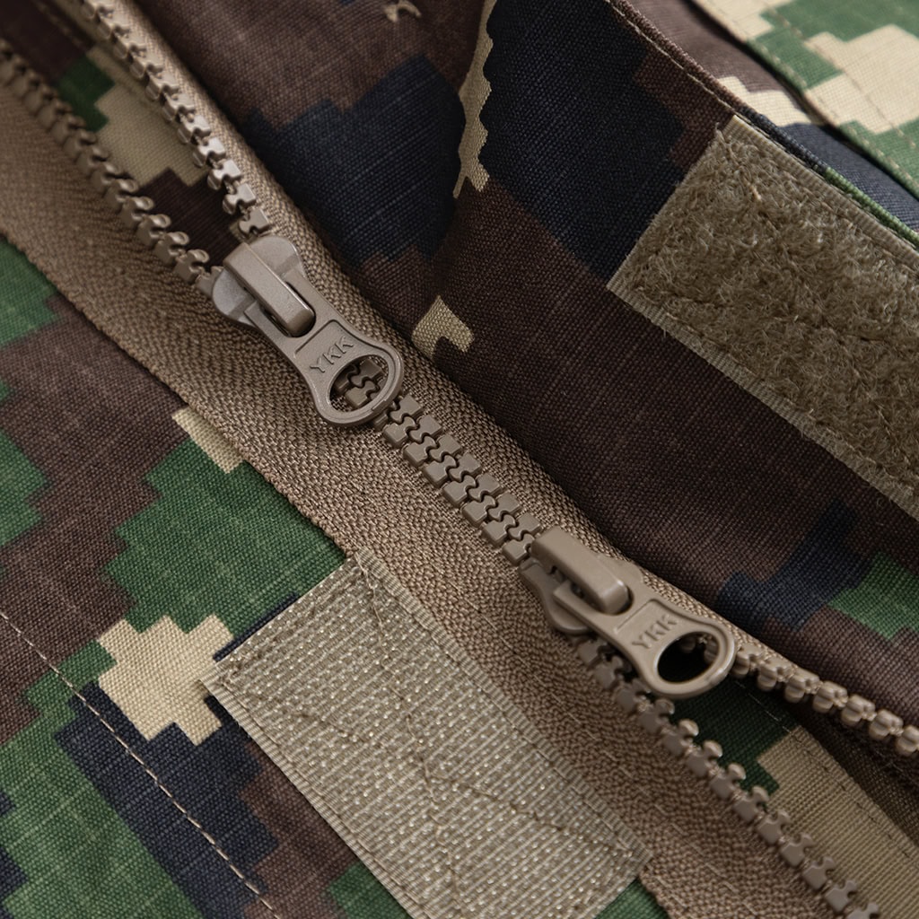 Detail of a heavy-duty zipper on the custom jungle digital combat uniform, showing its robust construction.
