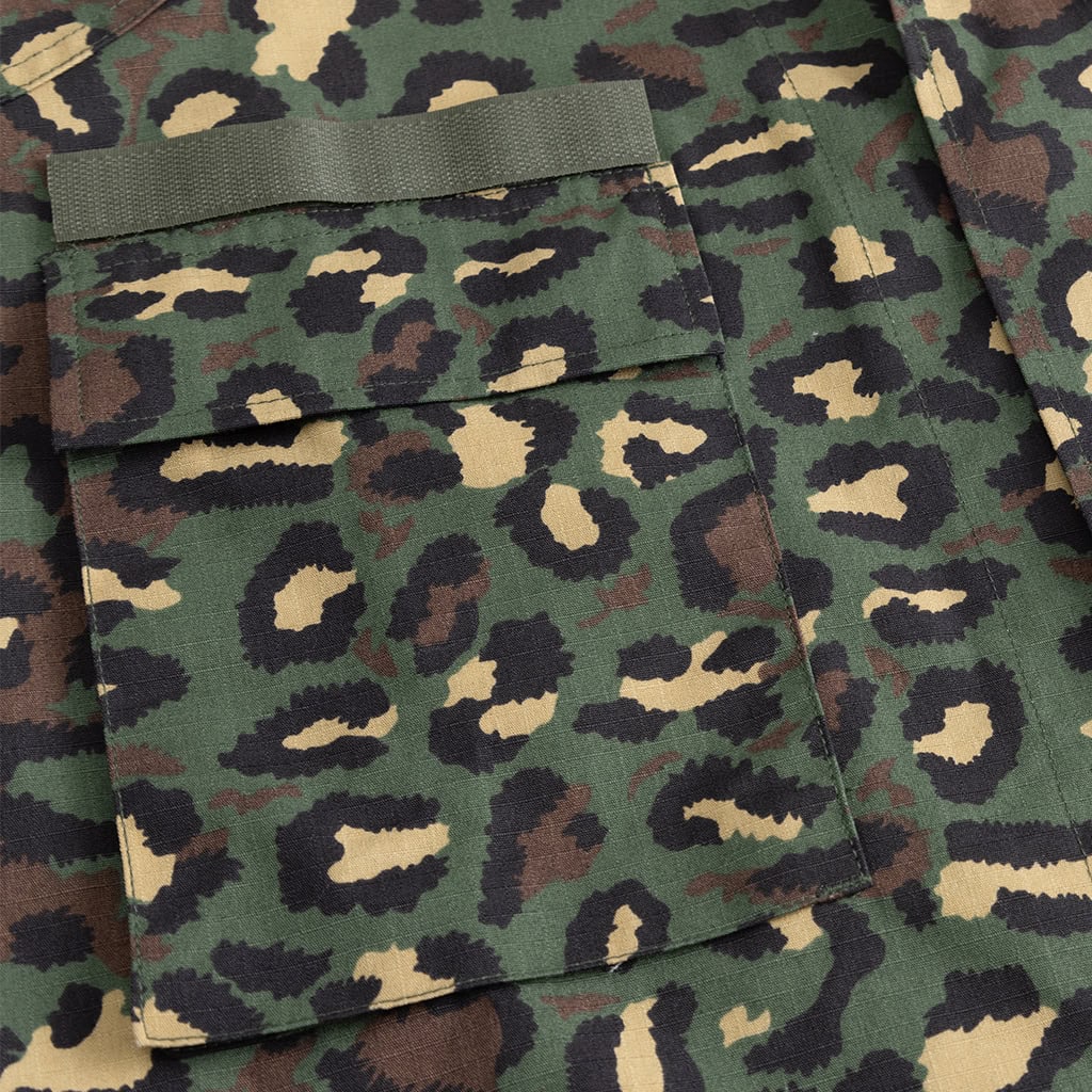 Close-up of the buttoned front bellow pockets on the custom leopard camo military BDU uniform jacket.