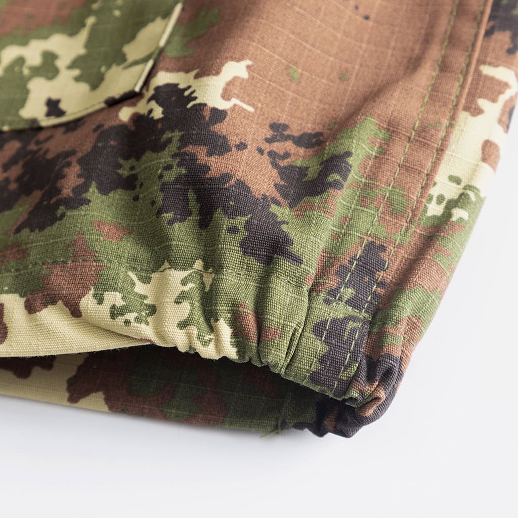 Detail of the drawstring leg opening on the custom Italian vegetato combat uniform trousers for a secure fit.