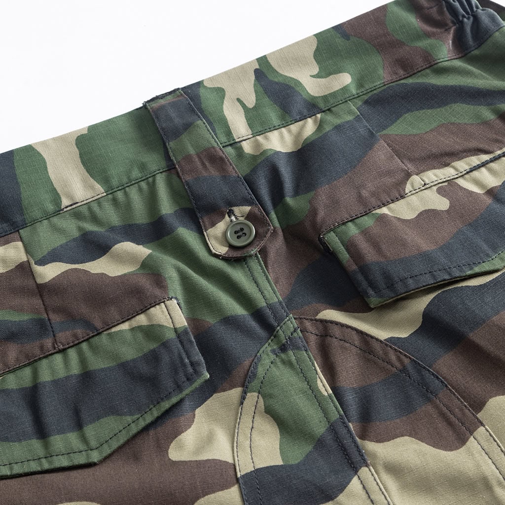Close-up of the multi-button waistband and slant pocket on the custom woodland camo combat uniform trousers.