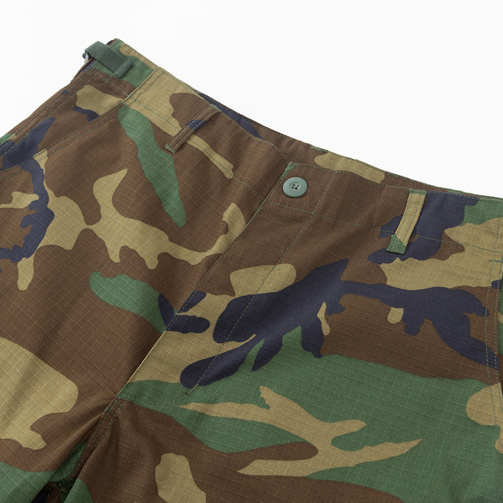 Detail of the button-fly and adjustable waistband on the custom woodland camo BDU uniform trousers.