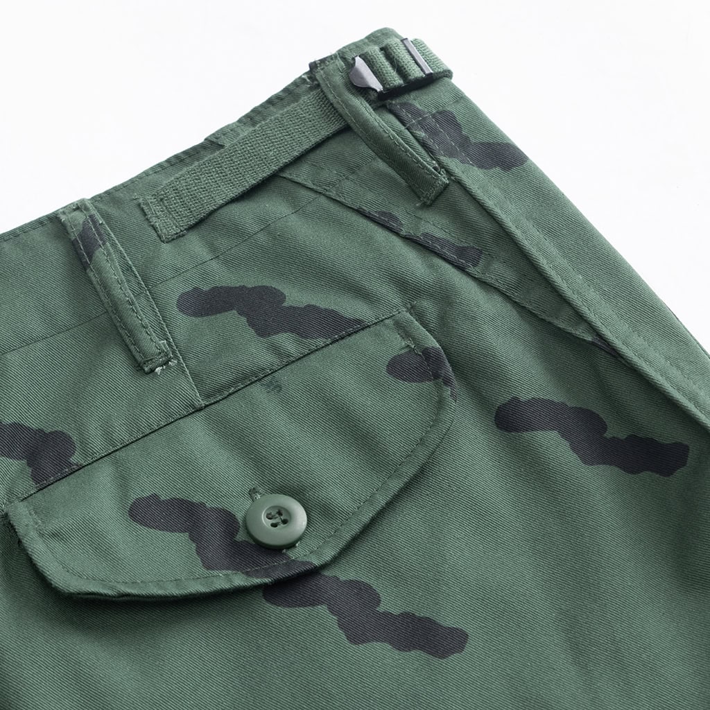 Close-up of the button-fly and pocket detail on the custom Tanzanian green camo uniform trousers.