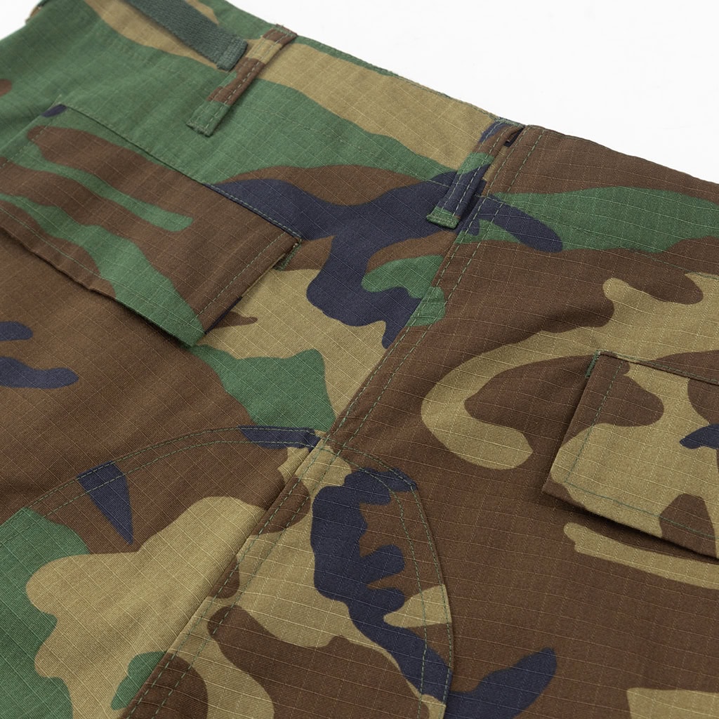 Close-up of the large, expandable side cargo pocket on the custom woodland camo BDU trousers.
