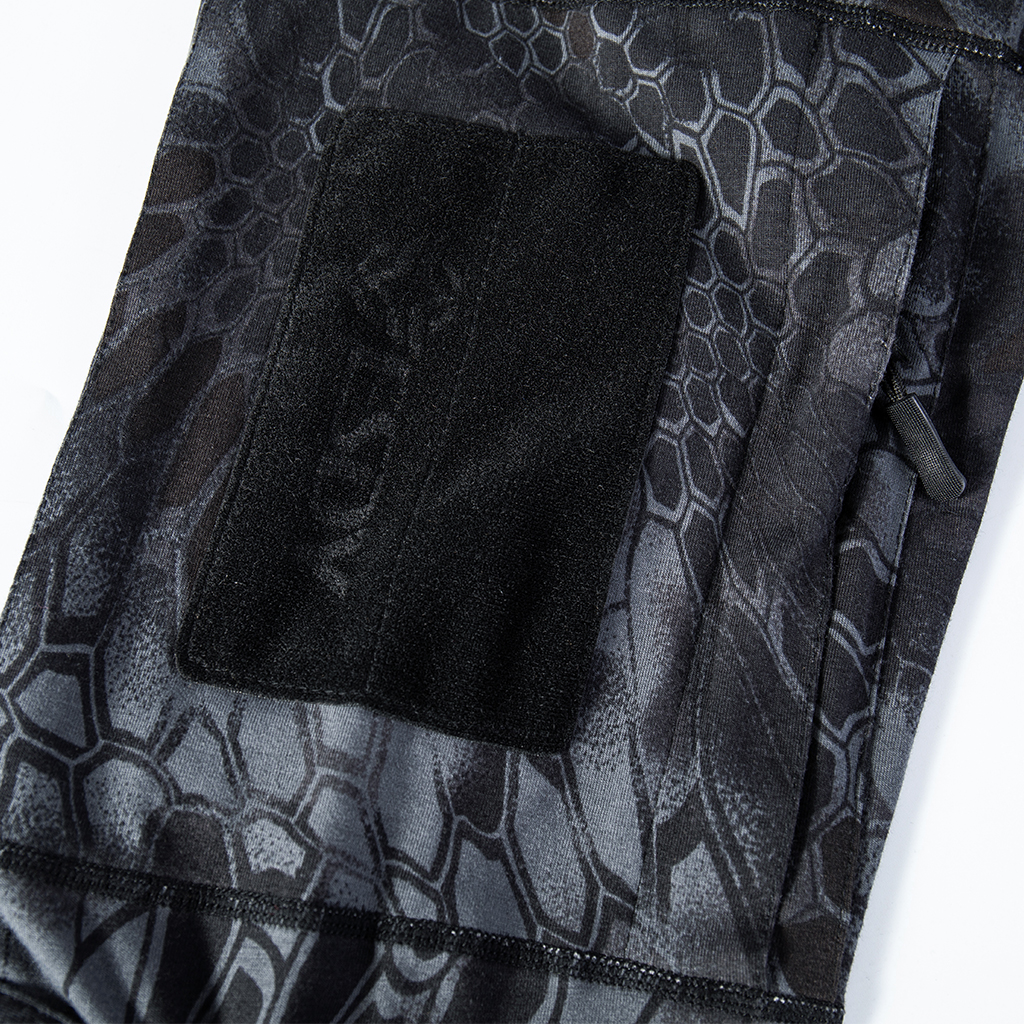 Close-up of the zippered arm pocket with velcro panels on the sleeve of the custom black python G4 long sleeve combat shirt.
