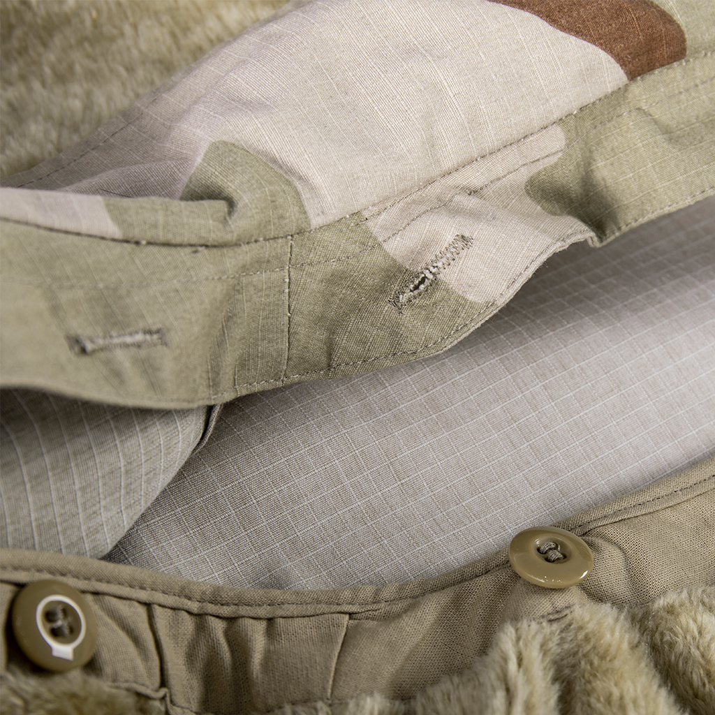 Detail of the interior button and stitching for attaching the removable liner inside the custom tri-color desert M65 jacket.