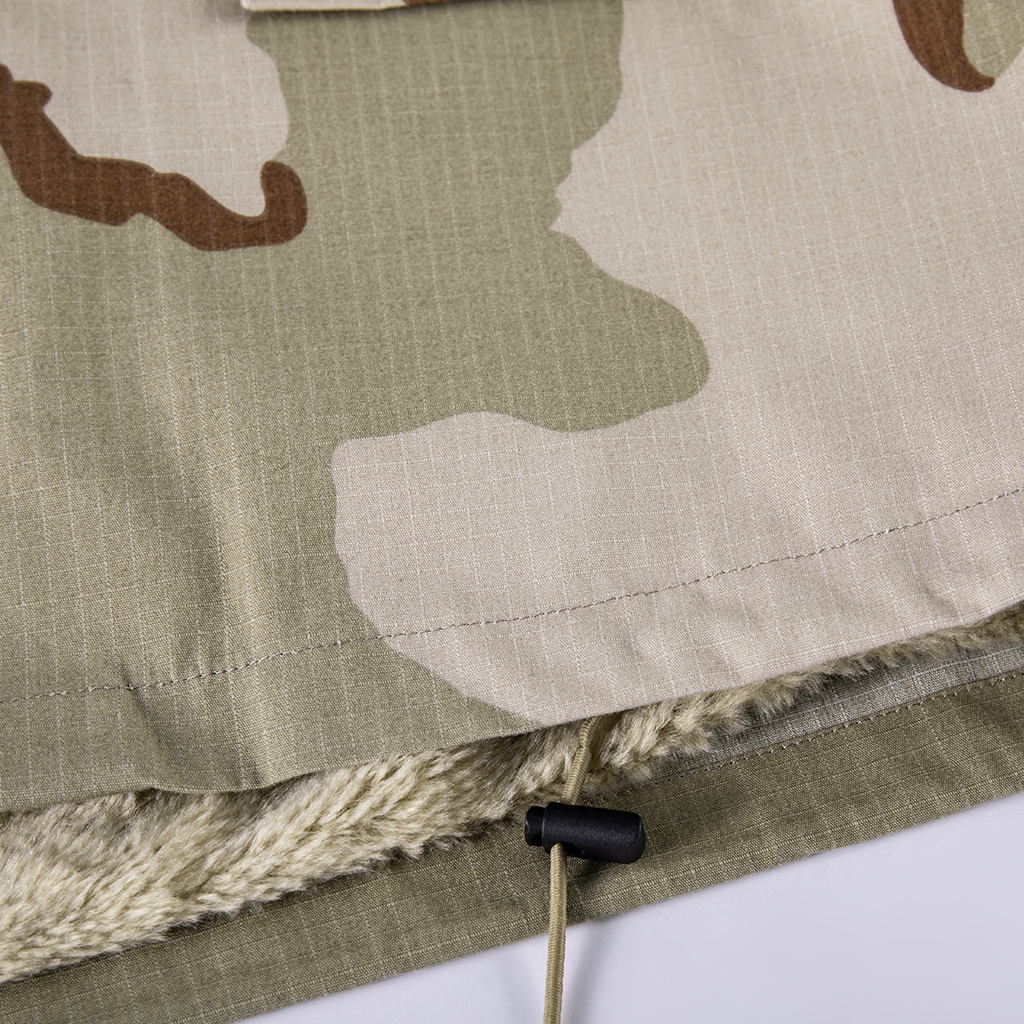 Close-up of the adjustable drawstring at the hem of the custom tri-color desert M65 jacket.
