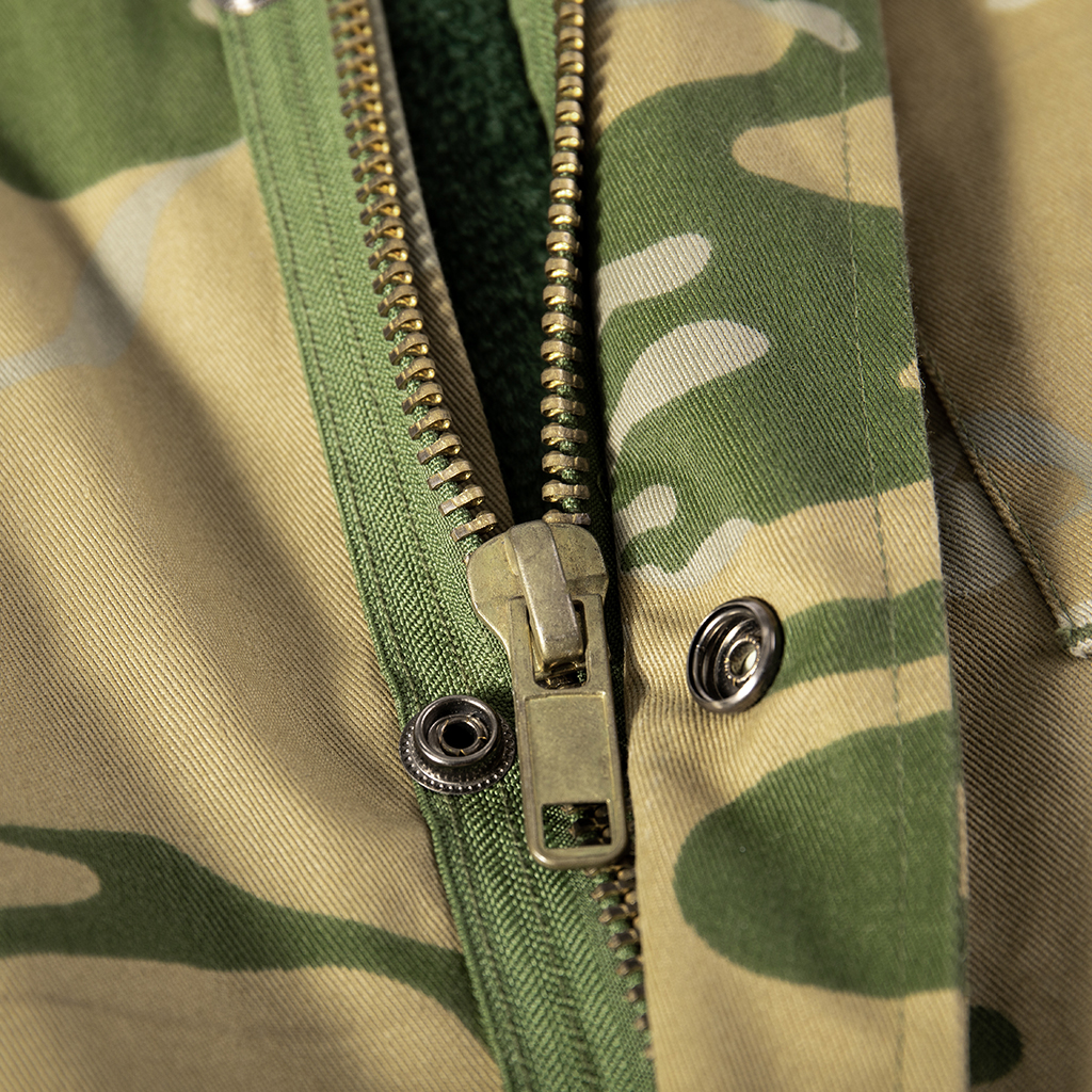 Close-up of the double-layer front closure with zipper and snap buttons on the custom Yemen camo M65 field jacket.