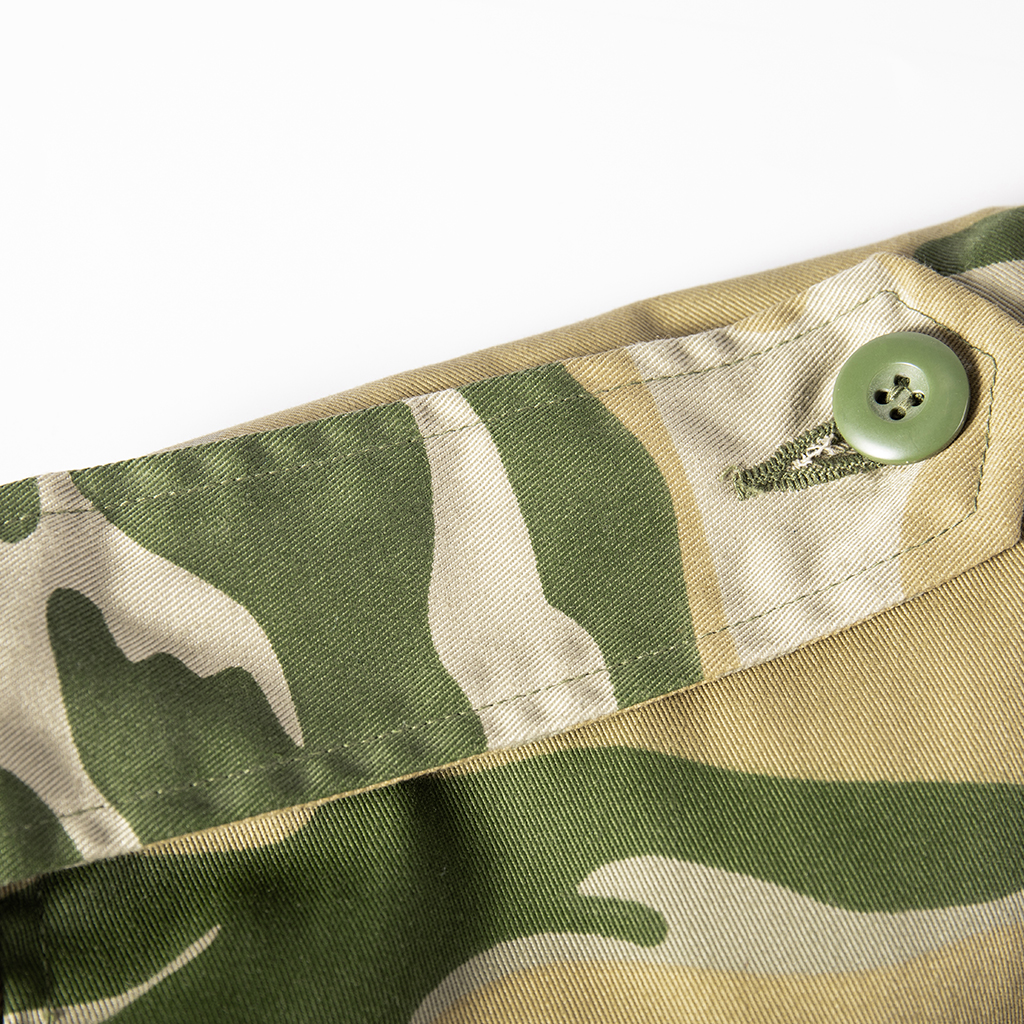 Close-up of the buttoned shoulder epaulette on the custom Yemen camo M65 field jacket.