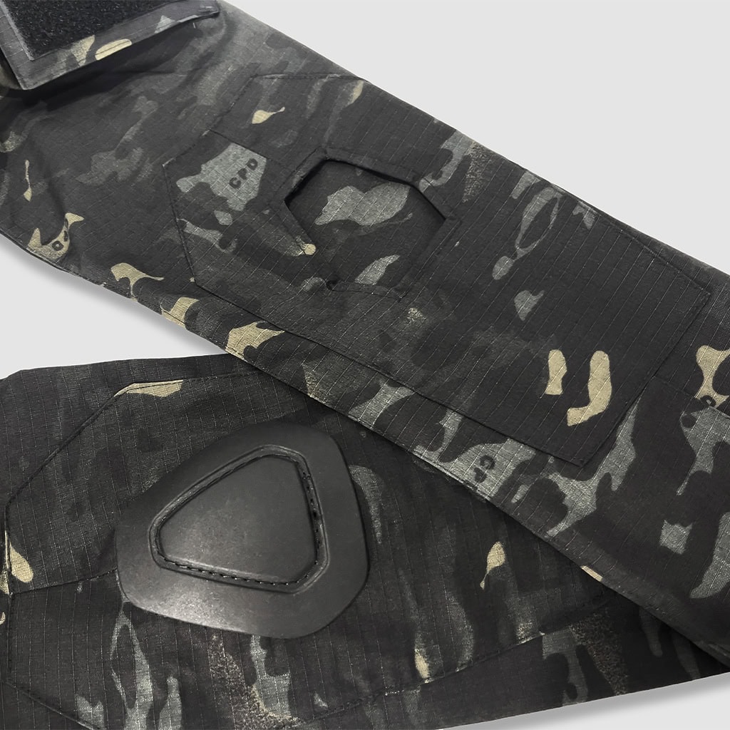 Detail of the integrated elbow pad pocket with a removable hard-shell pad on the custom black CP G2 combat shirt.