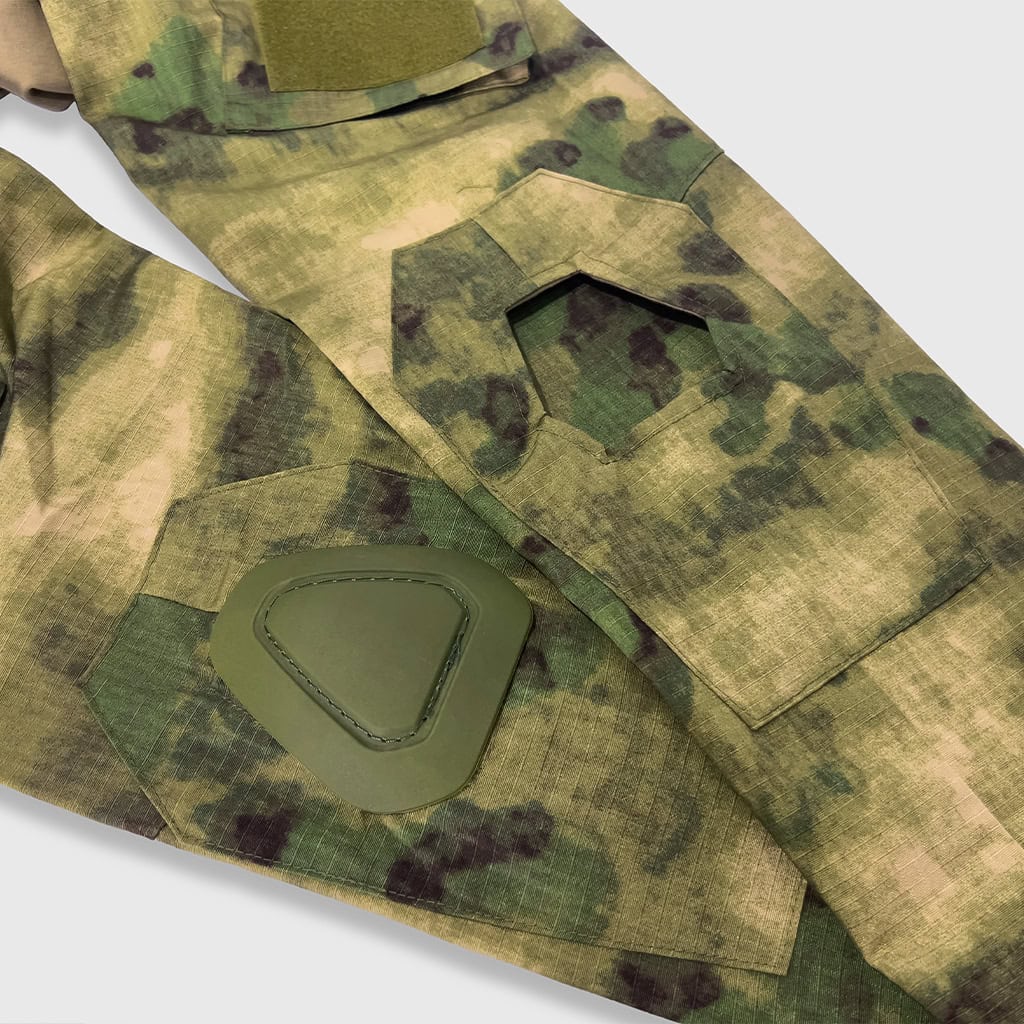 Detail of the integrated elbow pad pocket on the sleeve of the custom ATACS G2 combat shirt.