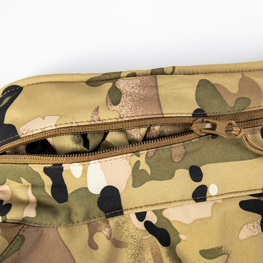 Close-up of the zippered arm pocket with velcro panel on the sleeve of the custom CP camo softshell tactical jacket.