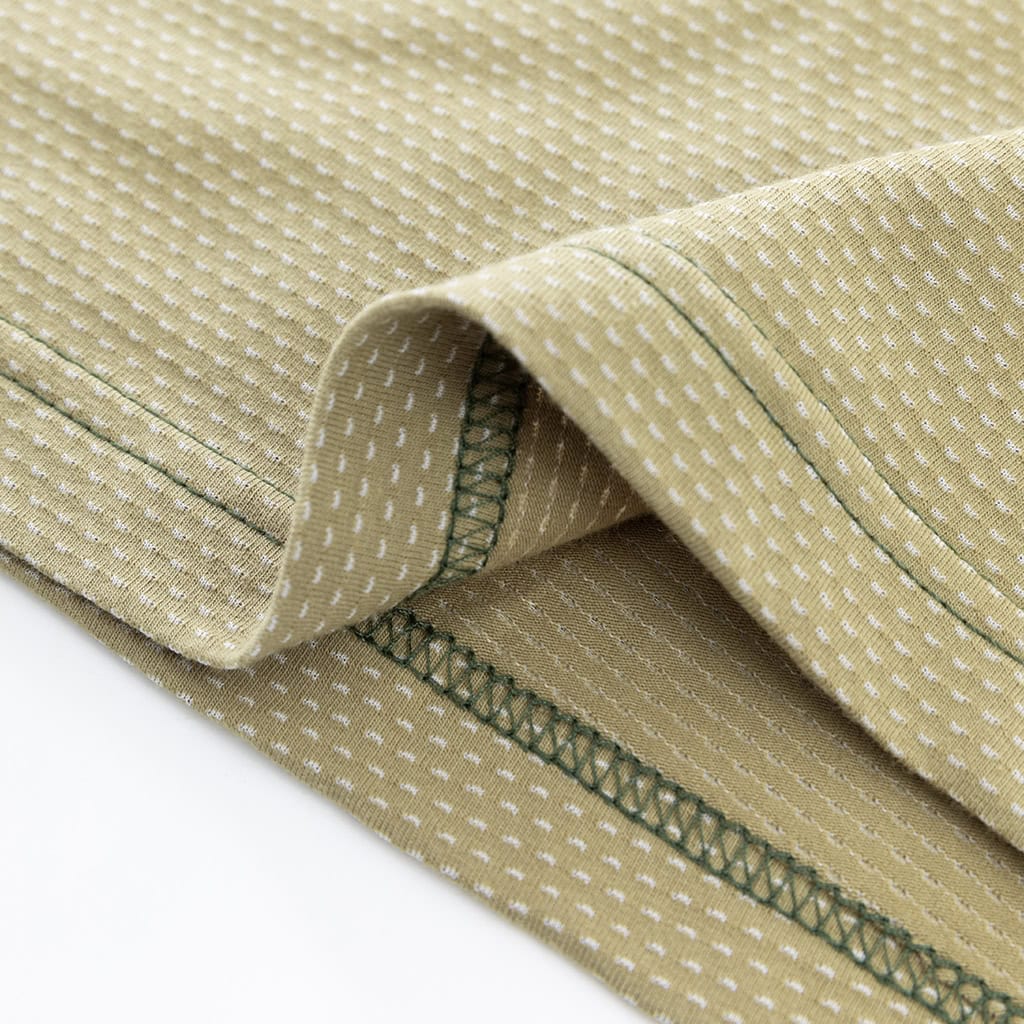 Close-up of the durable hem with locking process stitch on the custom woodland python G4 long sleeve combat shirt.