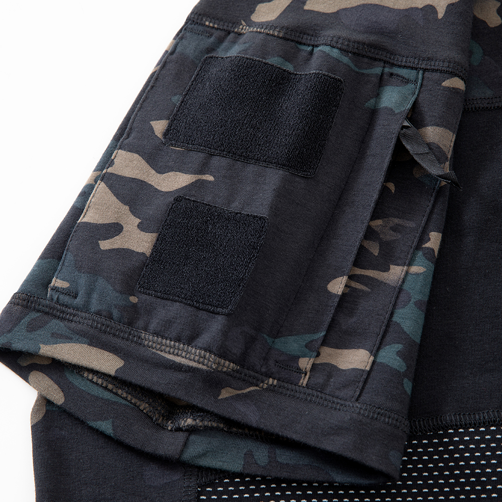 Close-up of the zippered arm pocket with velcro panels on the sleeve of the custom black CP G4 short sleeve combat shirt.
