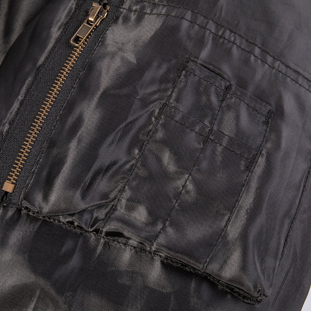 Close-up of the zippered utility and pen pocket on the sleeve of the custom black MA-1 flight jacket.