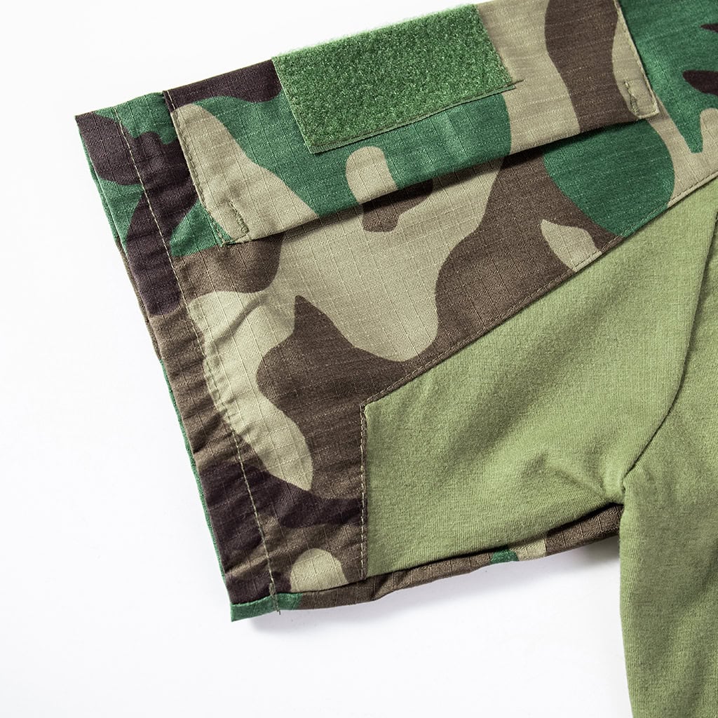 Detail of the gusseted underarm and sleeve construction on the woodland camo short sleeve combat shirt.