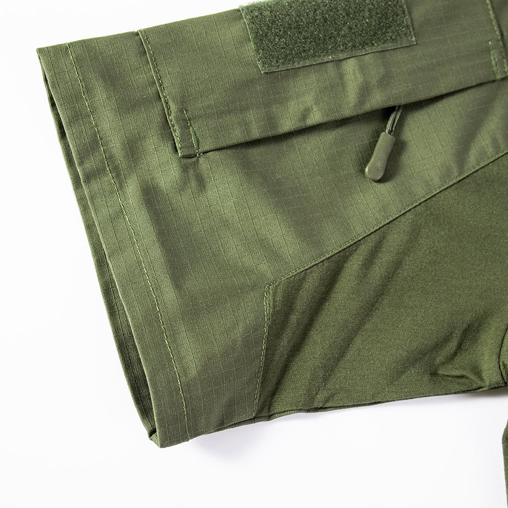 Detail of the zippered arm pocket with velcro panel on the sleeve of the olive green short sleeve tactical shirt.