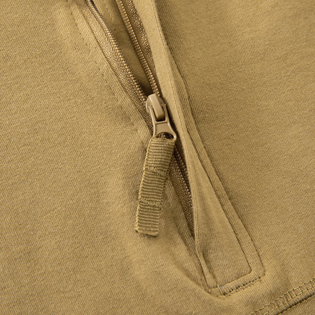 Close-up of the premium zipper pull tab at the neckline of the custom tan G4 short sleeve combat shirt.