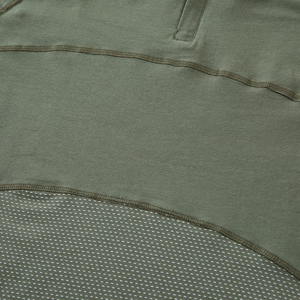 Detail of the breathable mesh fabric and reinforced seam on the lower torso of the custom olive green G4 short sleeve combat shirt.