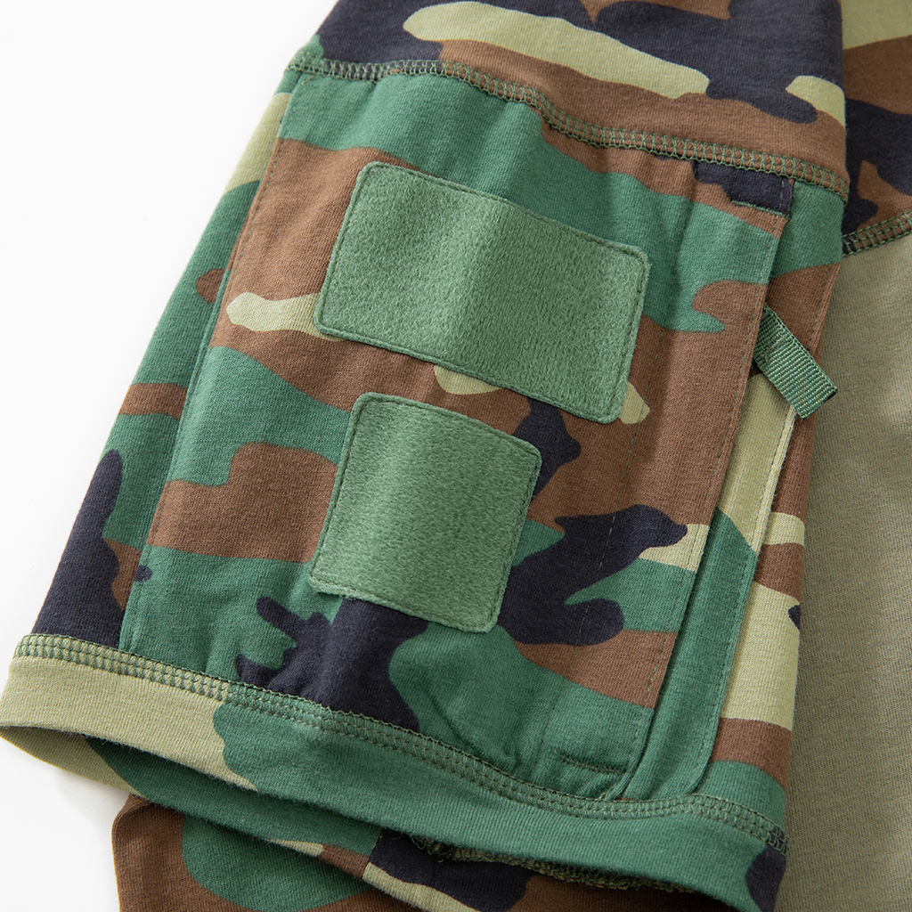 Close-up of the zippered arm pocket with velcro panels on the sleeve of the custom woodland camo G4 short sleeve combat shirt.