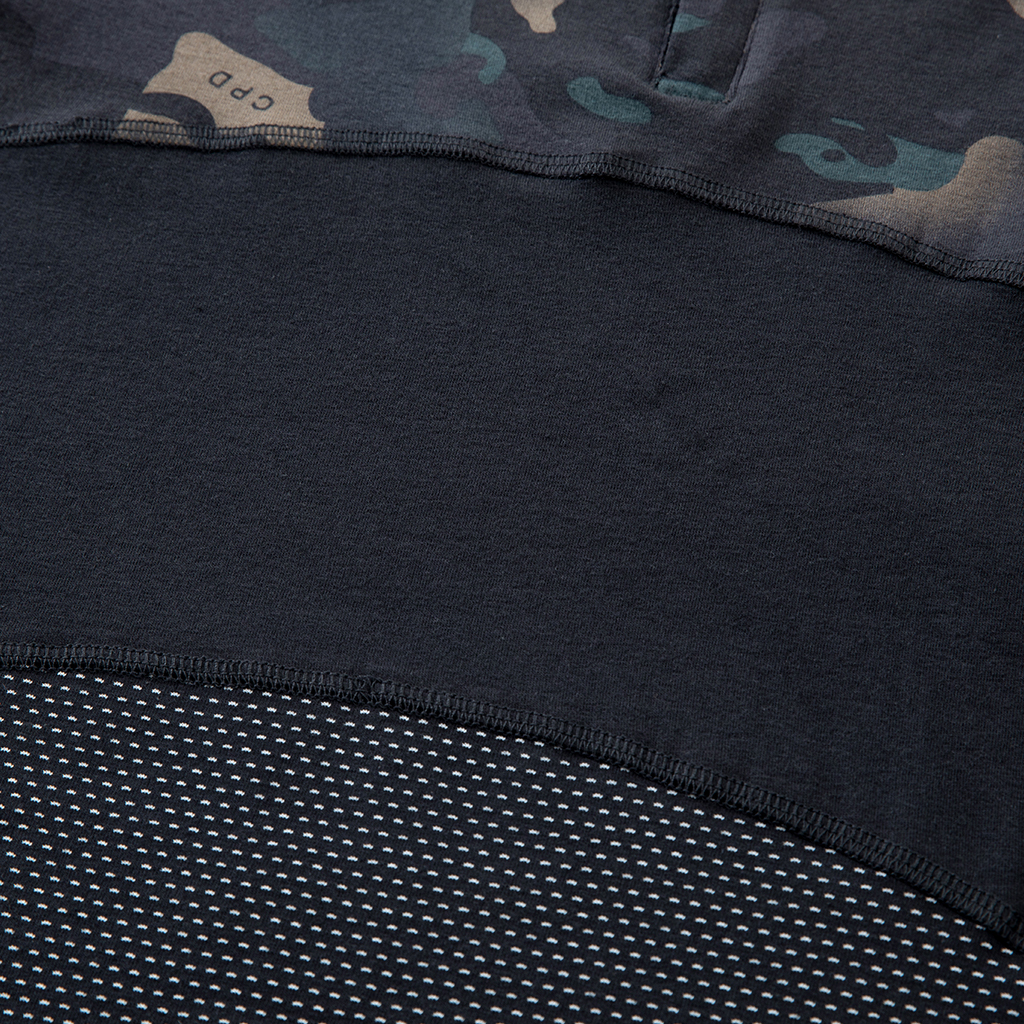 Detail of the highly breathable mesh fabric and reinforced seam on the lower torso of the custom black CP G4 short sleeve combat shirt.