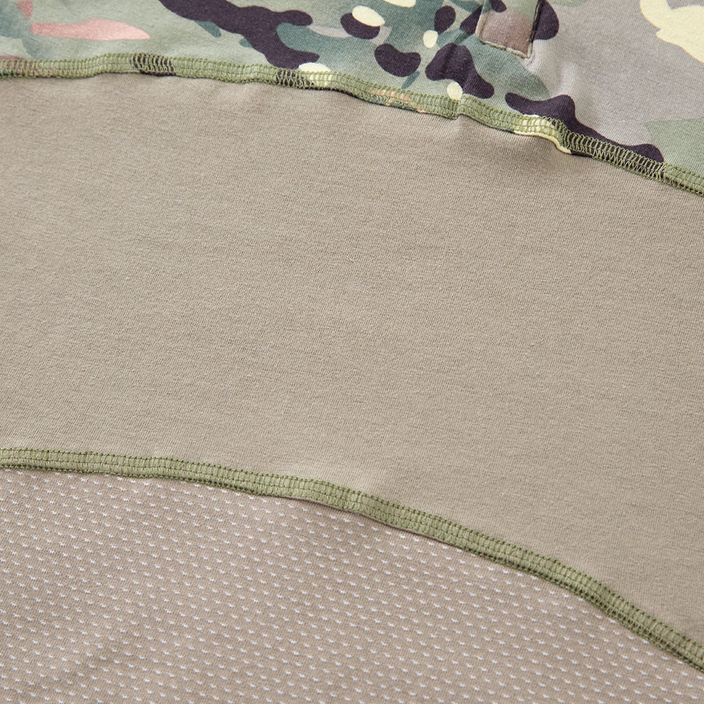 Detail of the highly breathable mesh fabric and reinforced seam on the lower torso of the custom CP camo G4 short sleeve combat shirt.