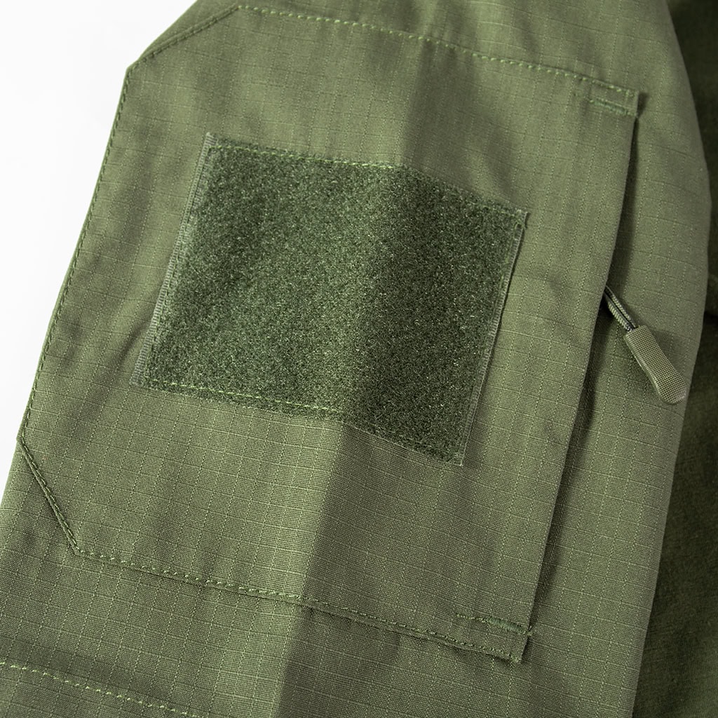 Close-up of the large velcro panel on the arm pocket of the custom olive green short sleeve tactical shirt.