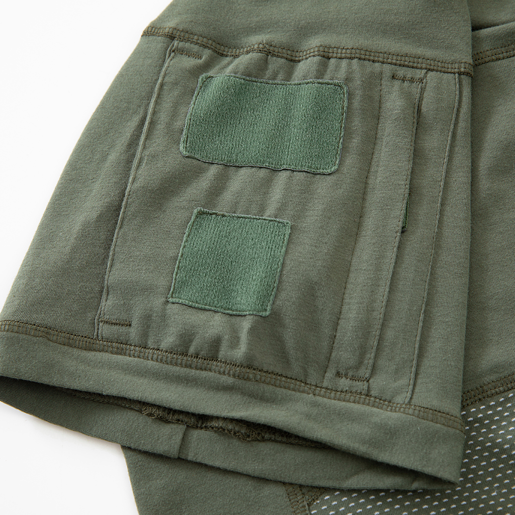 Close-up of the zippered arm pocket with velcro panels on the sleeve of the custom olive green G4 short sleeve combat shirt.