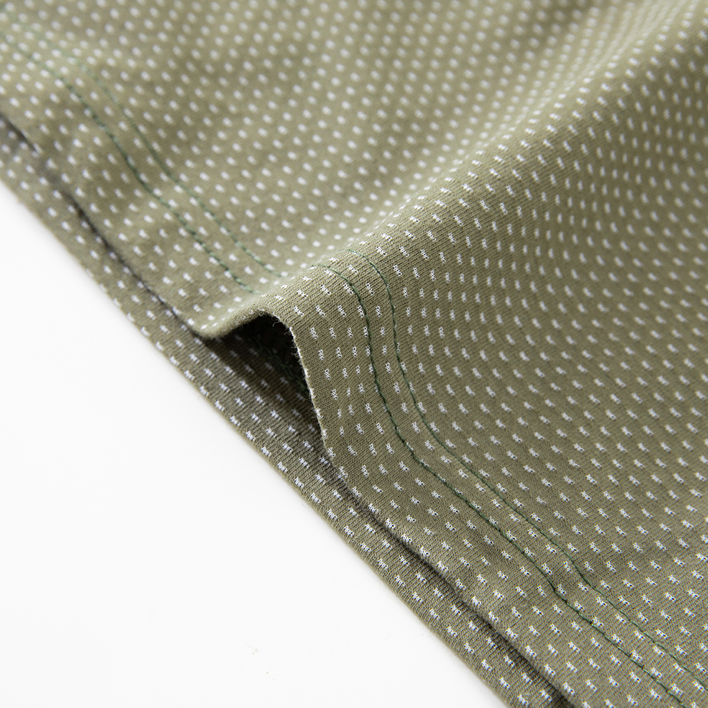Close-up of the durable hem with locking process stitch on the custom woodland camo G4 short sleeve combat shirt.