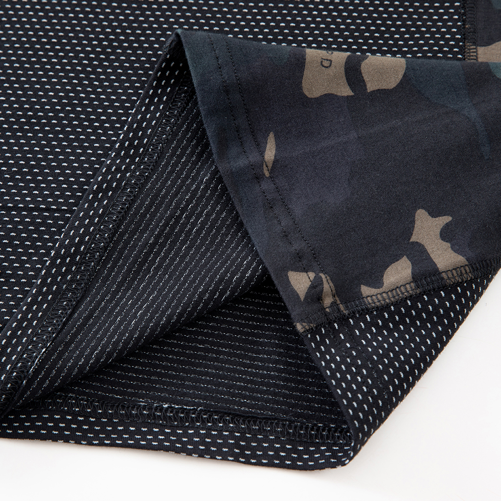 Close-up of the durable hem with locking process stitch on the custom black CP G4 short sleeve combat shirt.