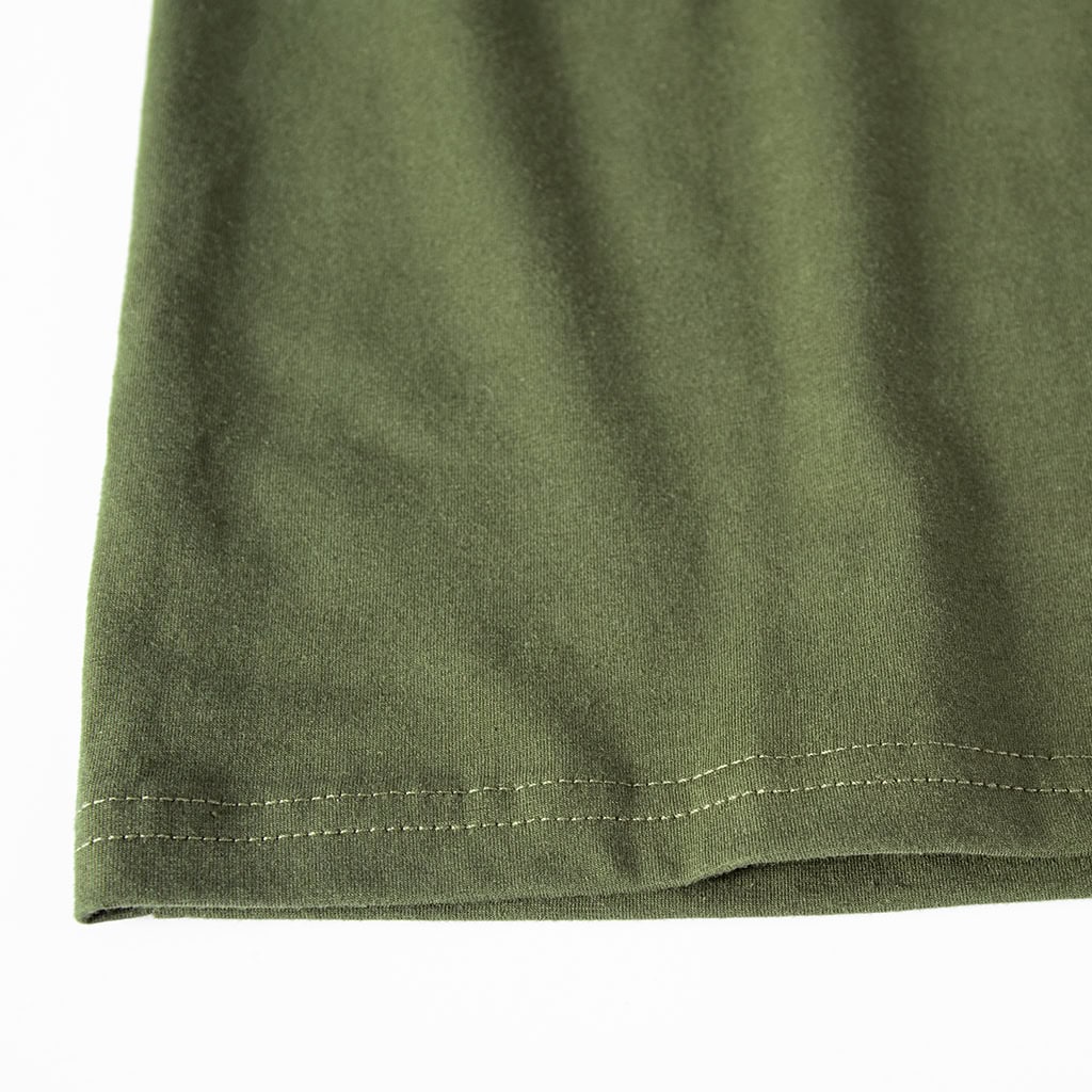Close-up of the double-stitched hem on the breathable torso of the custom olive green short sleeve tactical shirt.
