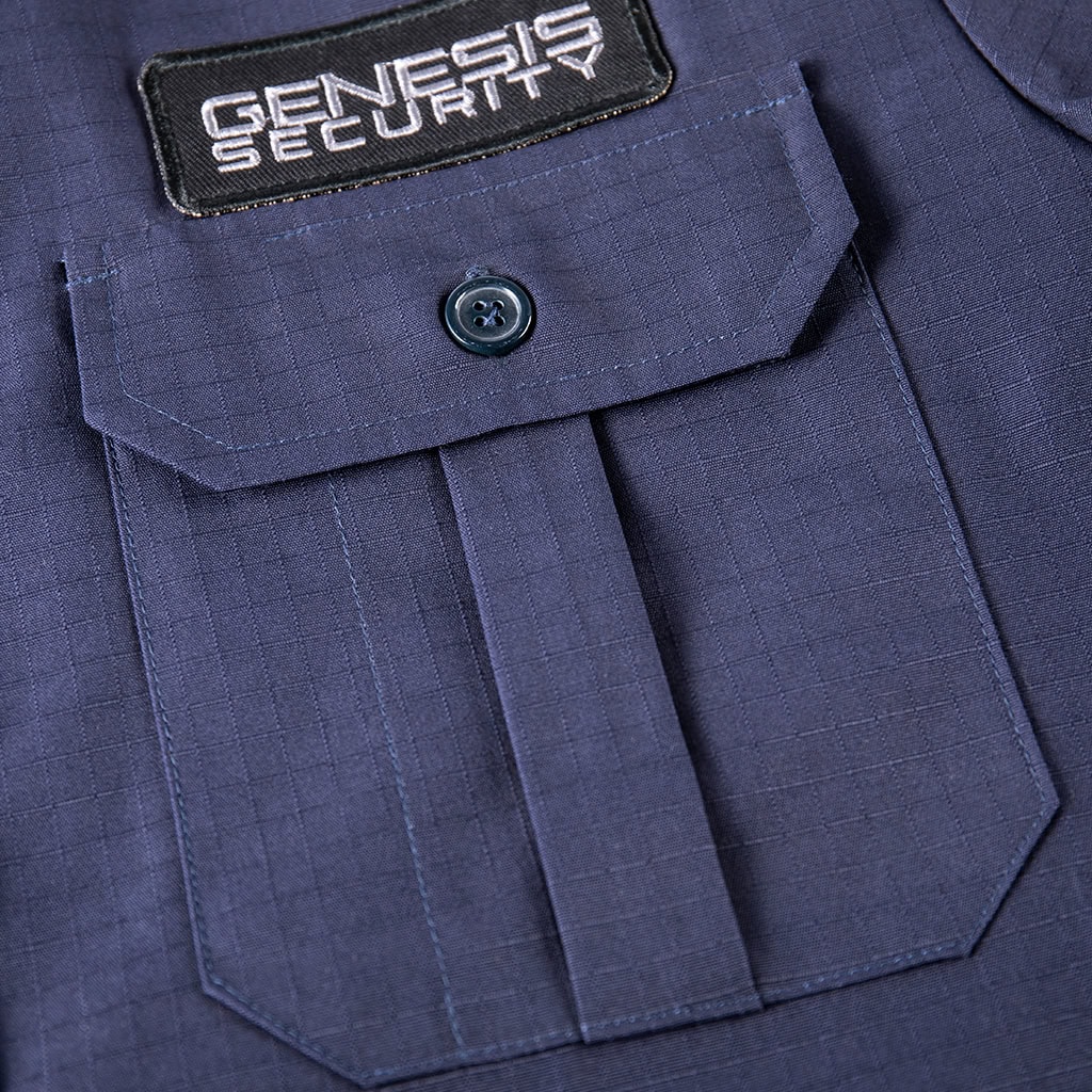 Detail of the pleated chest pocket and velcro panel on the custom navy blue ripstop security shirt, with a "Genesis Security" patch.