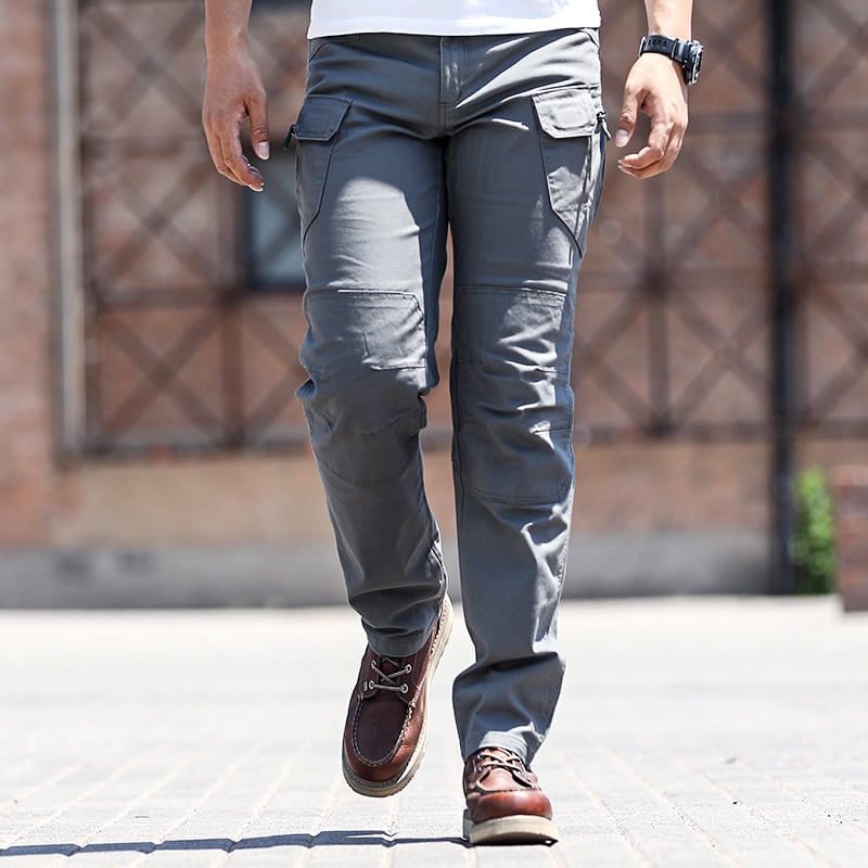 Front view of a man wearing the custom ripstop IX7 tactical pants in Grey Green, with hands in pockets.