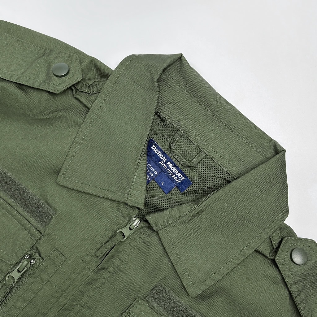 Close-up of the professional collar and zipper on the custom olive green tactical shirt.