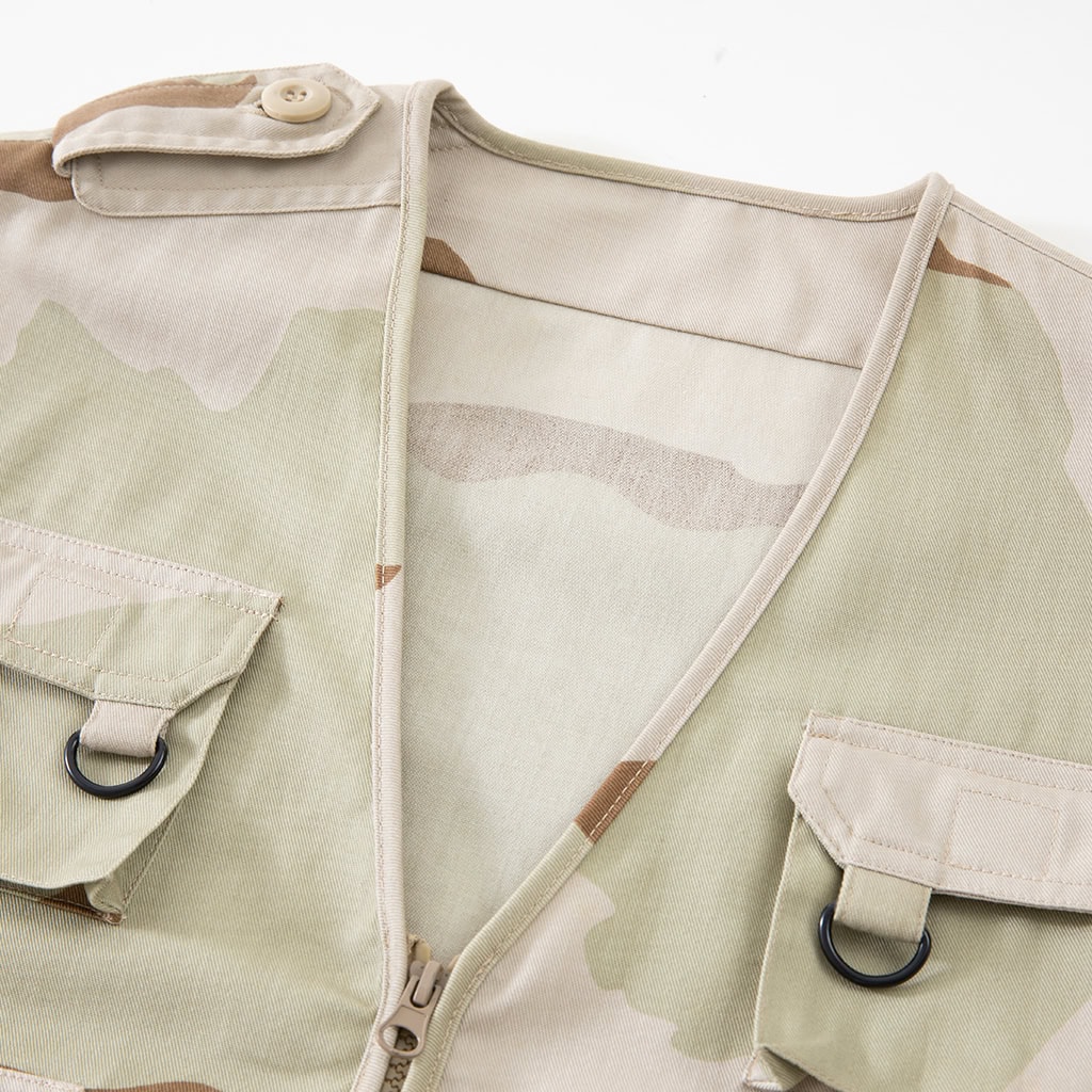Close-up of the V-neck collar and chest pockets on the custom tri-color desert tactical vest.