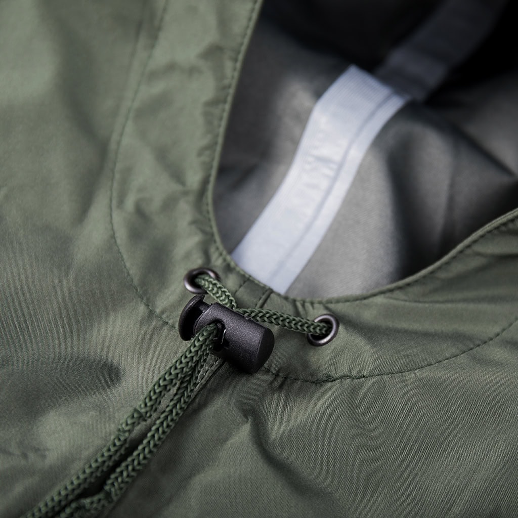 Close-up of the adjustable drawstring and cord lock on the hood of the custom olive green military rain poncho.