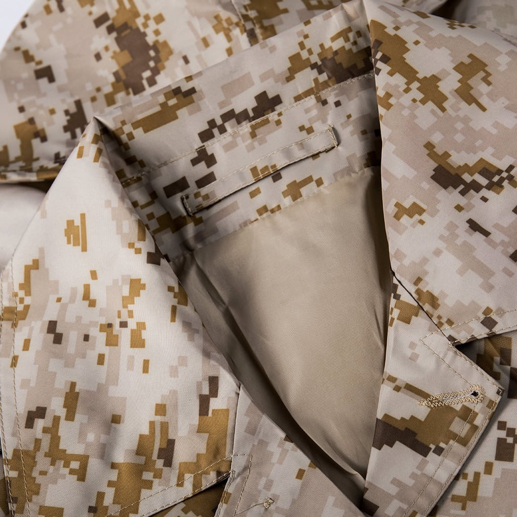 Close-up of the stowable hood and collar on the custom digital desert military raincoat.