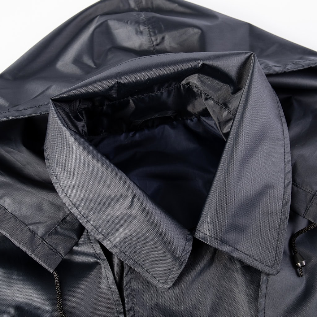 Close-up of the wide lapel collar and detachable hood on the custom navy blue waterproof trench coat.