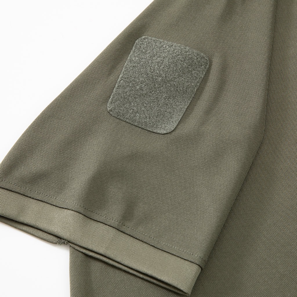 Detail of the velcro loop panel on the arm pocket of the custom olive green tactical polo shirt.