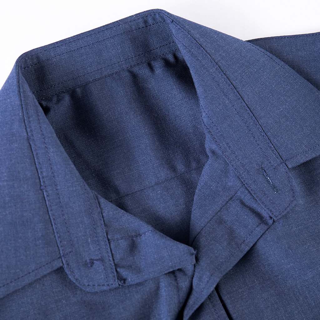Close-up of the professional lapel collar on the custom navy wool blend uniform shirt.