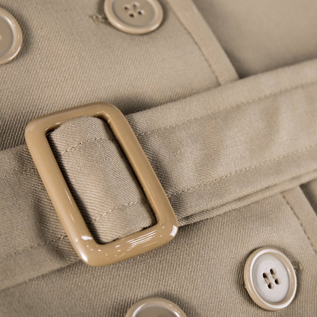 Detail of the adjustable waist belt and buckle on the custom khaki military officer trench coat.