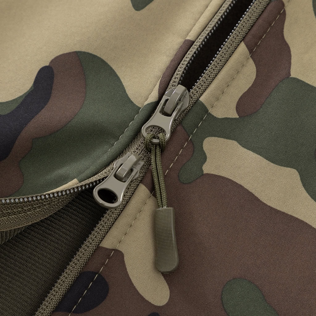 Detail of the premium zipper pull tab at the neckline of the custom woodland camo softshell jacket.
