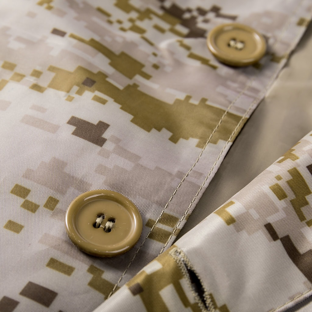 Detail of the high-quality buttons on the front placket of the custom digital desert military raincoat.