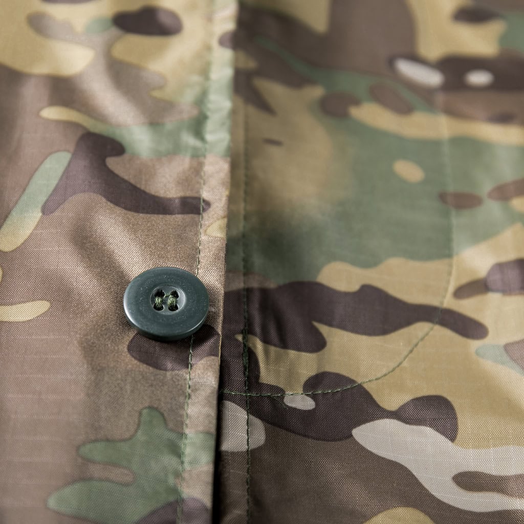 Detail of a high-end custom button on the front of the CP camo waterproof long raincoat.