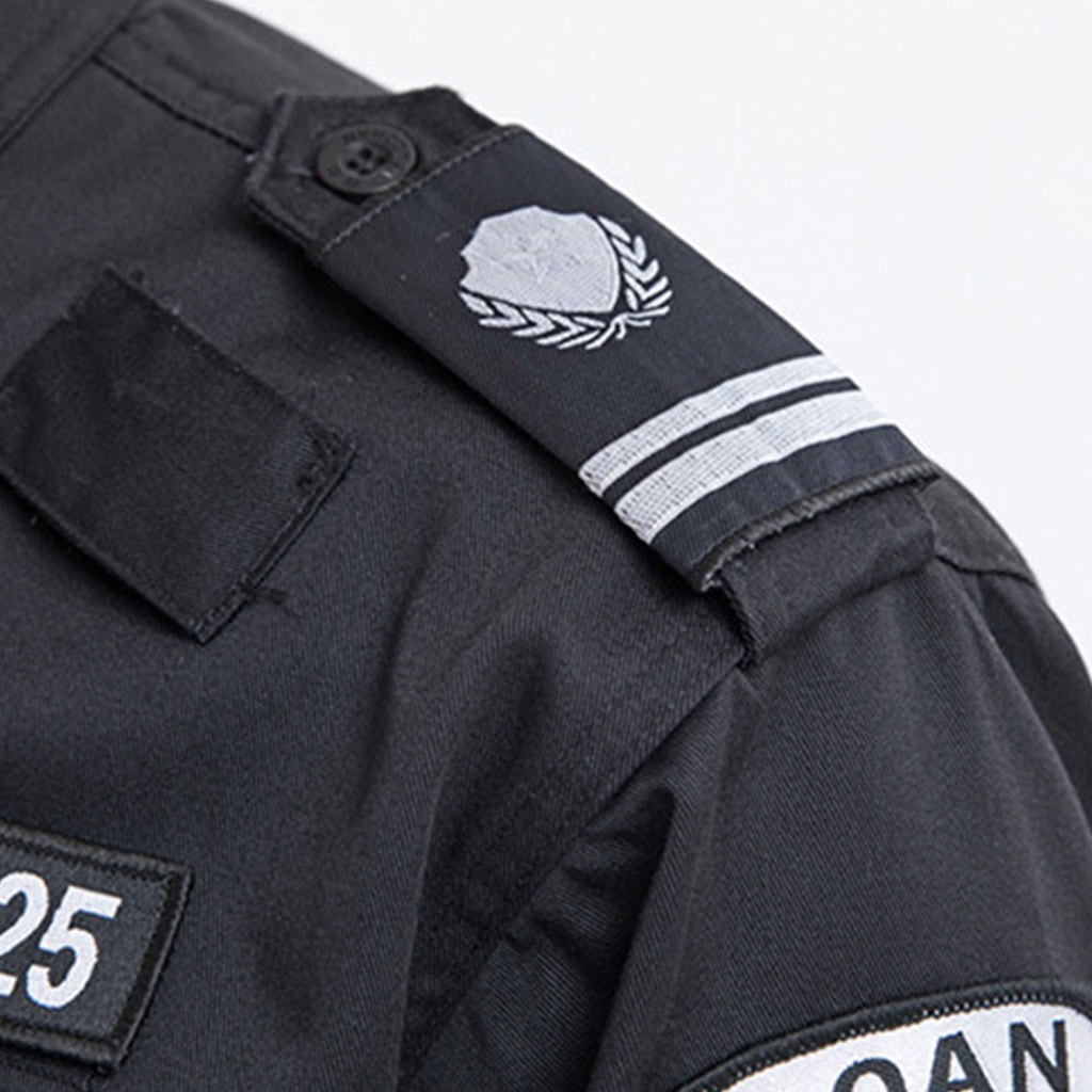 Close-up of the detachable shoulder tab (epaulette) with rank insignia on the custom black security guard uniform.