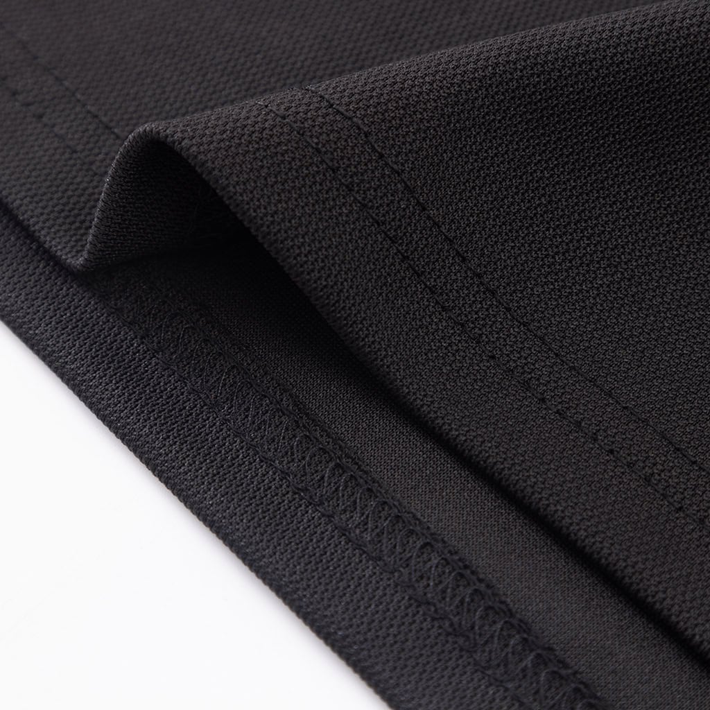Close-up of the durable, reinforced hem on the custom long sleeve security polo shirt.
