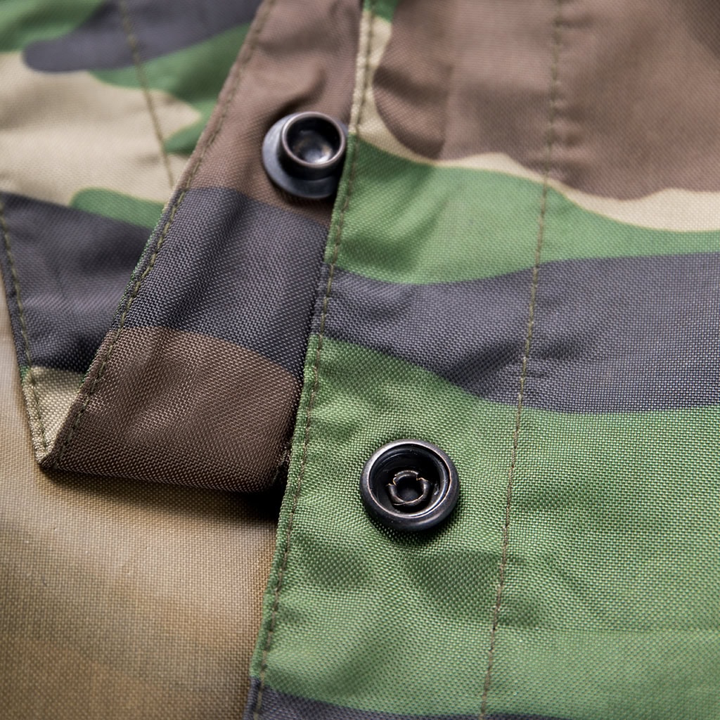 Close-up of the durable snap buttons on the side of the custom Nepal camo military rain poncho.