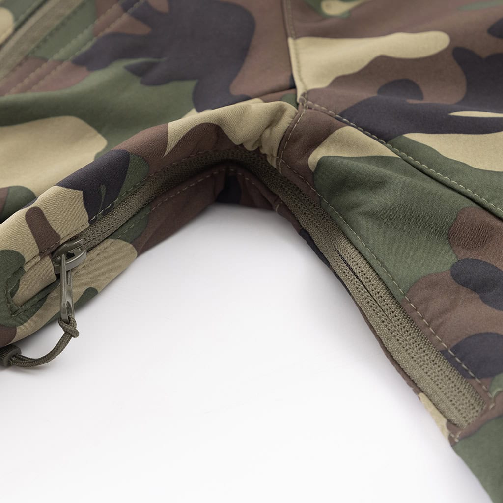 Close-up of a zippered chest pocket on the custom woodland camo softshell tactical jacket.